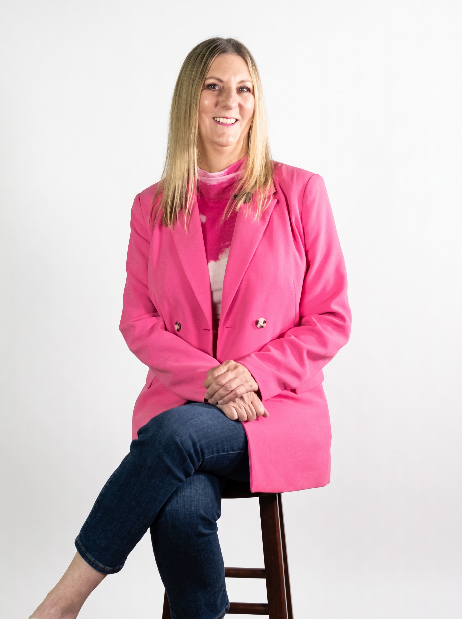 Julie Castro, publishing professional with Fiesta Publishing and workshop guide, in a bright pink blazer